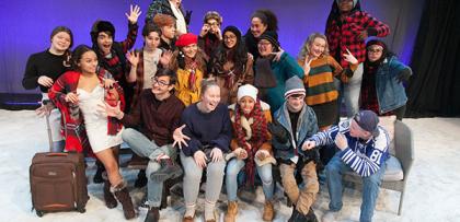 group of students on stage in costume pose together